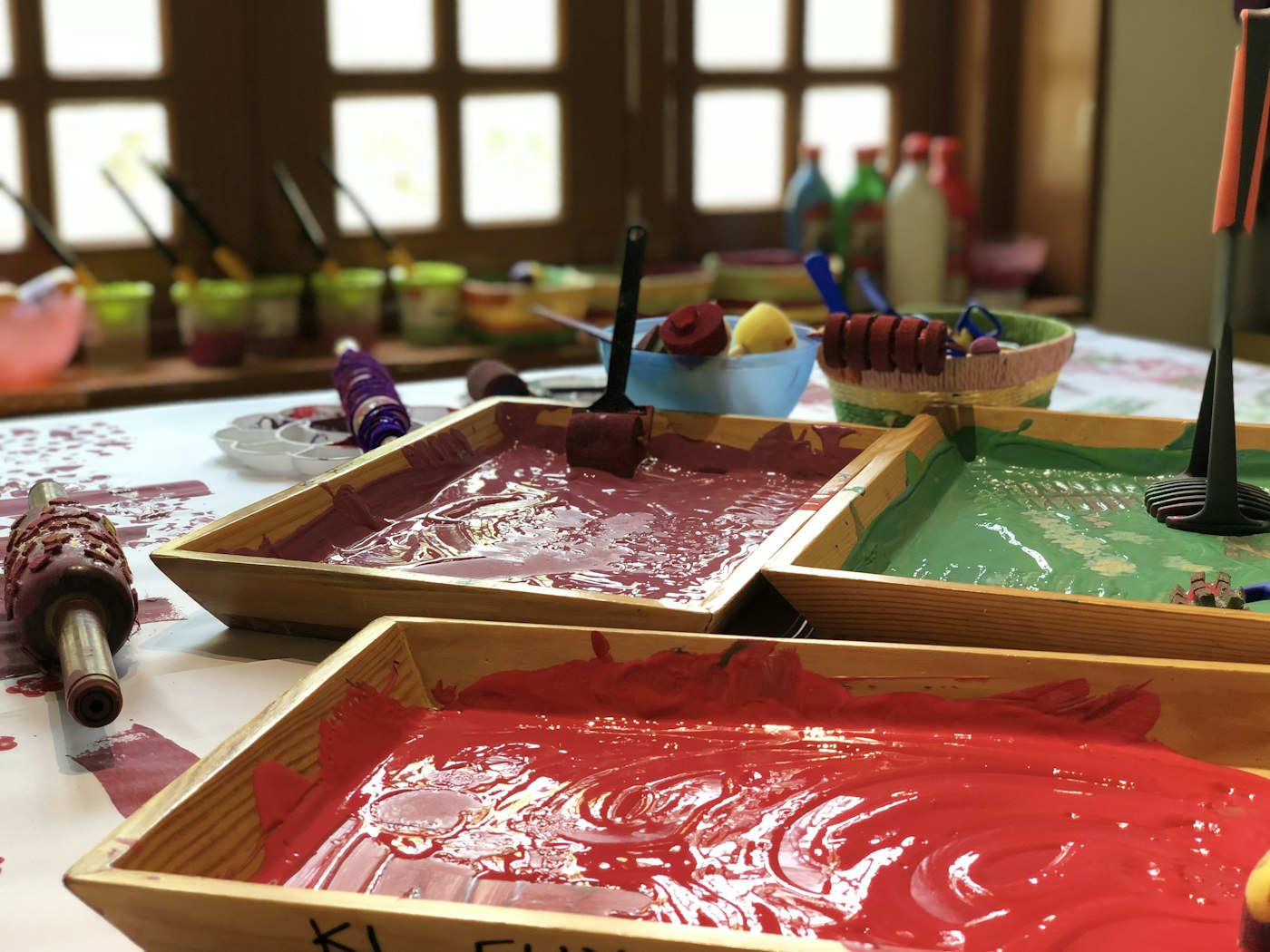 Colorful printmaking trays prepared for an early-learning art activity